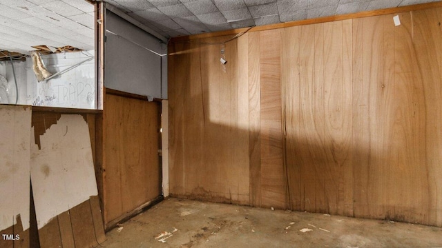 interior space with wood walls and concrete floors