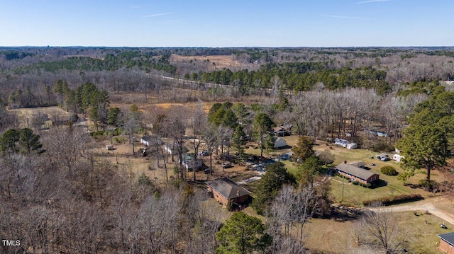 birds eye view of property with a view of trees