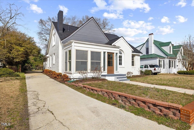 view of front of property with a front lawn and a chimney