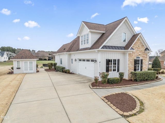 view of front of property with board and batten siding, concrete driveway, stone siding, and a garage