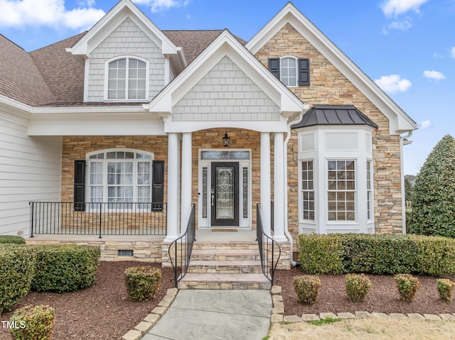 view of front of house with metal roof, a shingled roof, crawl space, and a porch