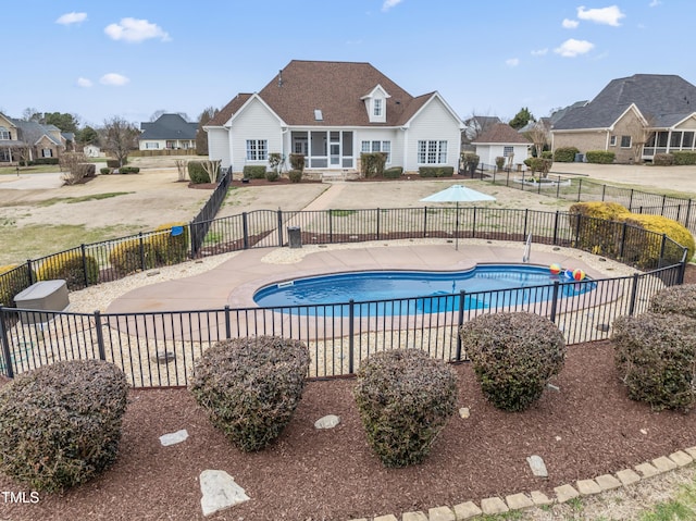 view of swimming pool featuring a residential view, fence, a fenced in pool, and a patio