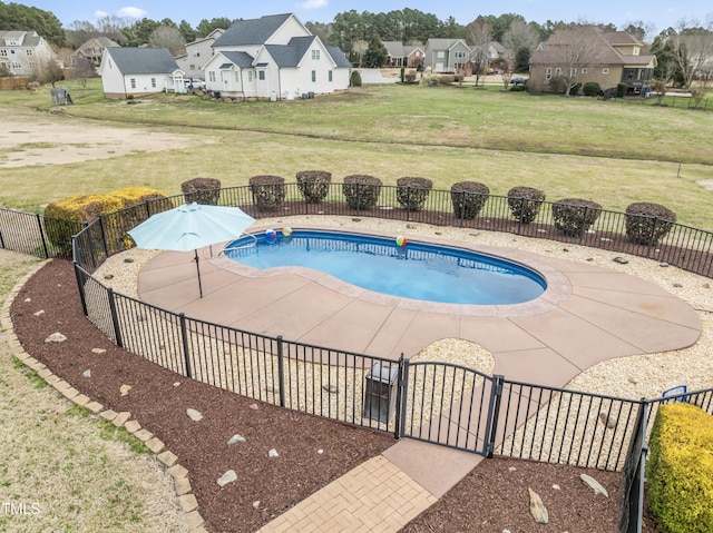 view of swimming pool with fence, a yard, a gate, a residential view, and a fenced in pool