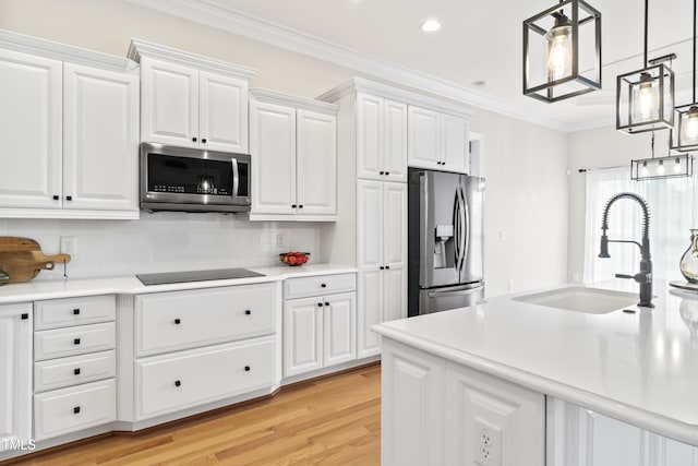 kitchen with stainless steel appliances, a sink, light countertops, backsplash, and crown molding