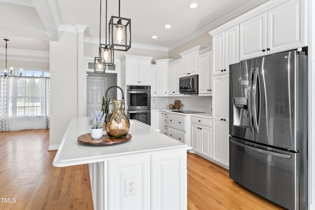 kitchen with light wood-style flooring, white cabinets, light countertops, appliances with stainless steel finishes, and crown molding