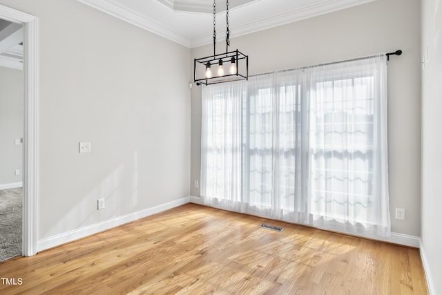 unfurnished dining area featuring a wealth of natural light, visible vents, and crown molding