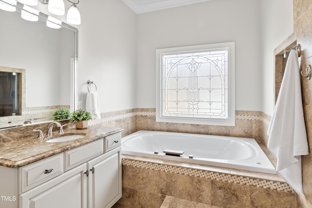 bathroom featuring crown molding, vanity, and a bath