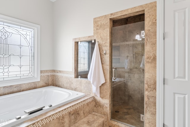 full bathroom with a garden tub and a shower stall