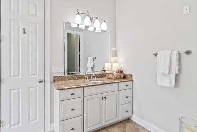 bathroom with vanity and baseboards