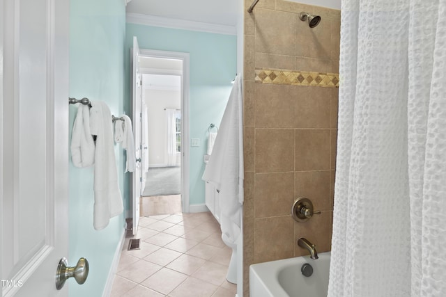 full bath featuring shower / tub combo, visible vents, baseboards, ornamental molding, and tile patterned flooring