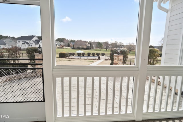 sunroom featuring a residential view