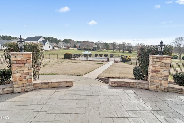 view of patio with a residential view and fence