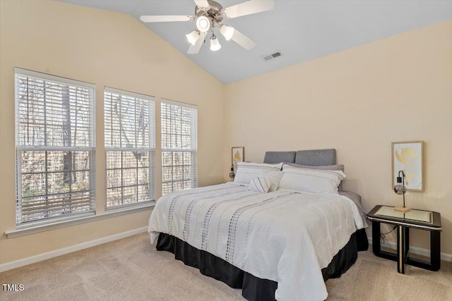 carpeted bedroom with lofted ceiling, baseboards, visible vents, and ceiling fan