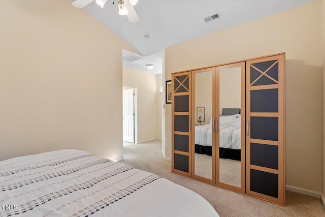 bedroom featuring lofted ceiling, baseboards, visible vents, and light colored carpet