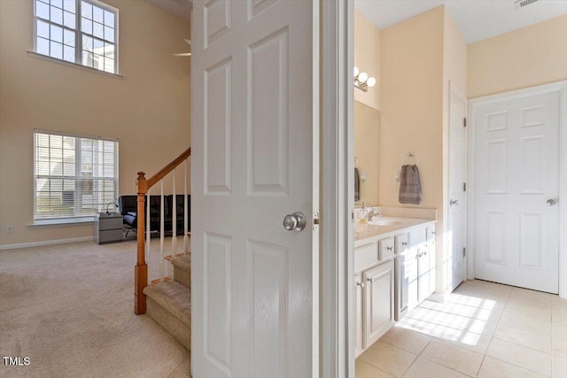 bathroom with visible vents, tile patterned flooring, vanity, and a healthy amount of sunlight