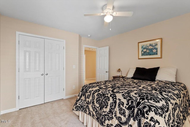 carpeted bedroom featuring a closet, ceiling fan, and baseboards