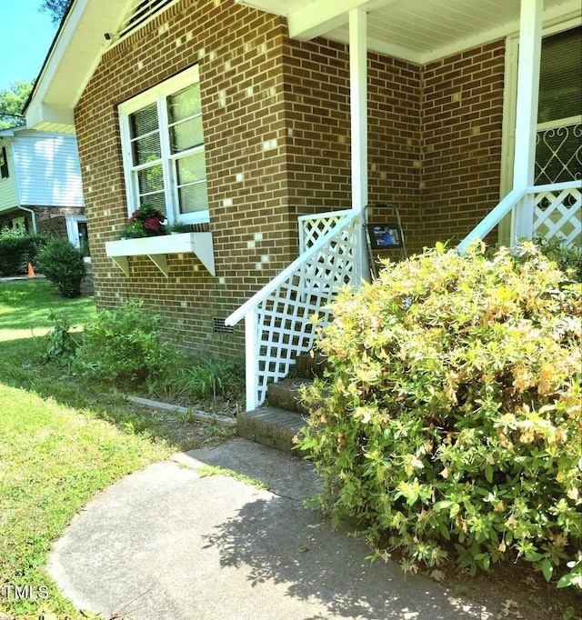 property entrance featuring brick siding