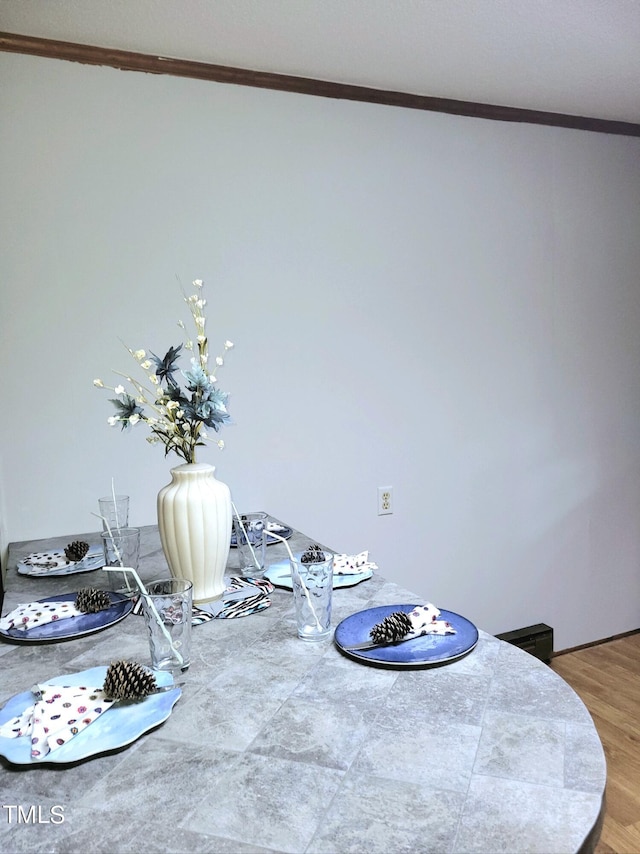 room details featuring ornamental molding and wood finished floors