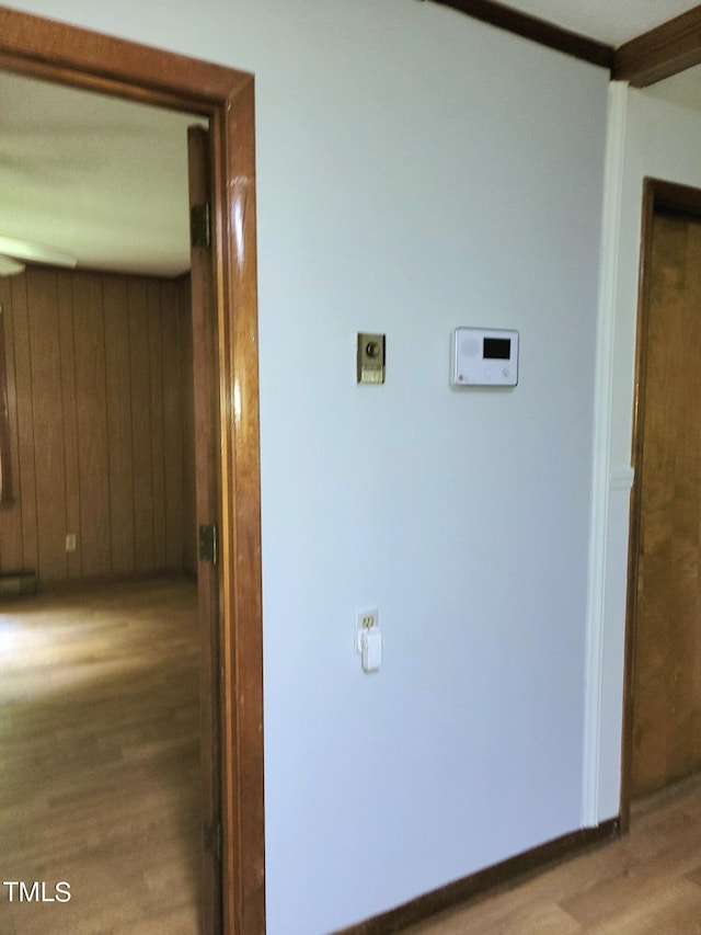 hall featuring wood walls and wood finished floors