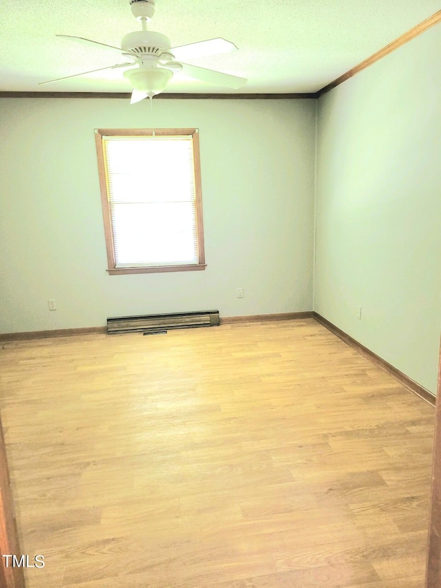 empty room featuring baseboards, a ceiling fan, a baseboard radiator, ornamental molding, and light wood-type flooring