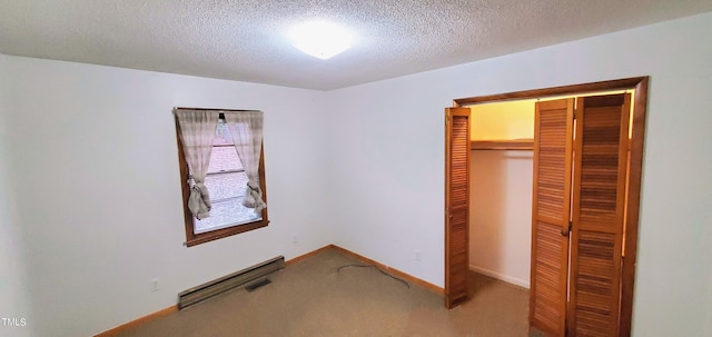 unfurnished bedroom featuring a textured ceiling, a closet, carpet, and baseboards