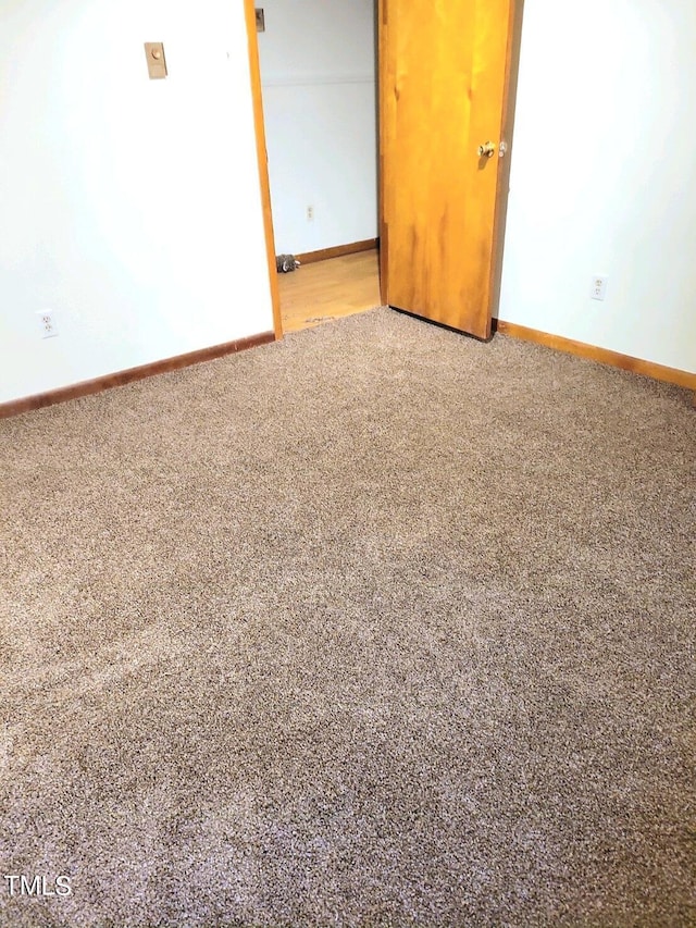 spare room with carpet flooring and baseboards