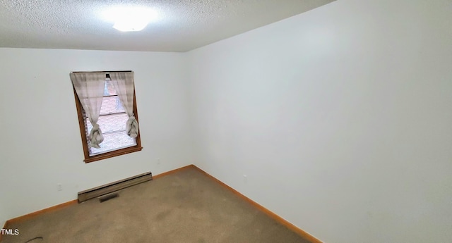 carpeted empty room featuring a textured ceiling and baseboards