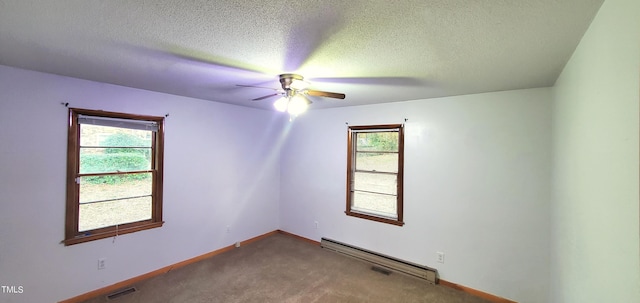 unfurnished room featuring carpet, visible vents, baseboard heating, a textured ceiling, and baseboards