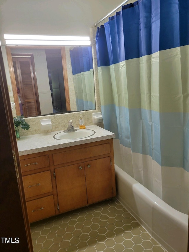 full bath featuring shower / bath combo with shower curtain and vanity