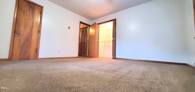 carpeted spare room with baseboards