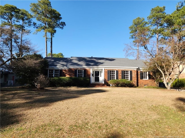 ranch-style home with a front lawn and brick siding