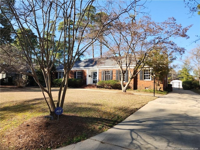 ranch-style house with crawl space, brick siding, and a front lawn