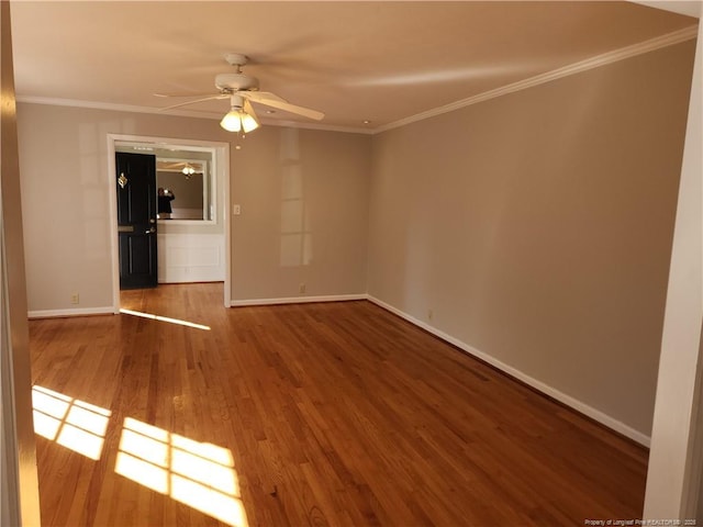 unfurnished room featuring ceiling fan, baseboards, crown molding, and wood finished floors