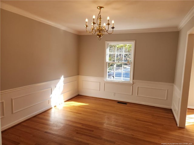 2814 Millbrook Rd, Fayetteville, NC 28303 - empty room featuring a chandelier, visible vents, crown molding, and wood finished floors