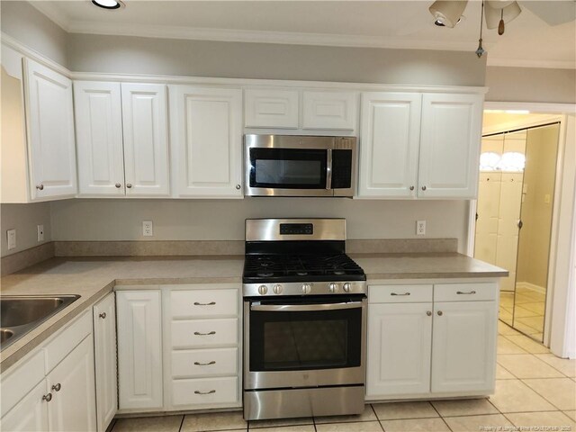 2814 Millbrook Rd, Fayetteville, NC 28303 - kitchen with white cabinetry, appliances with stainless steel finishes, light countertops, and ornamental molding