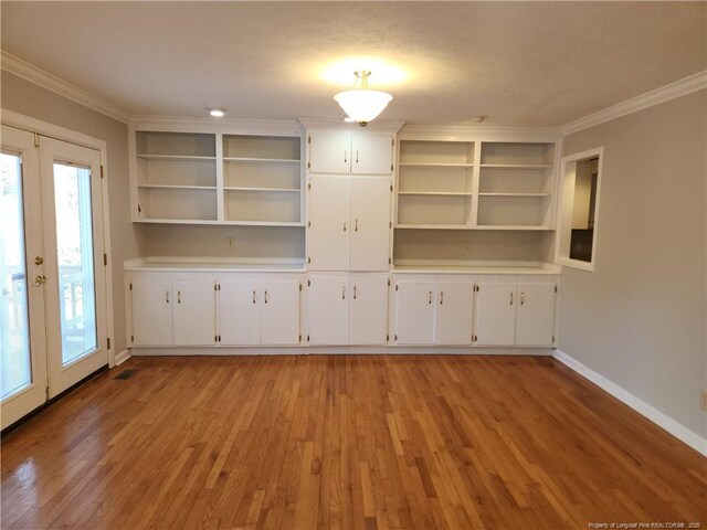 2814 Millbrook Rd, Fayetteville, NC 28303 - empty room featuring baseboards, french doors, ornamental molding, and light wood-style floors