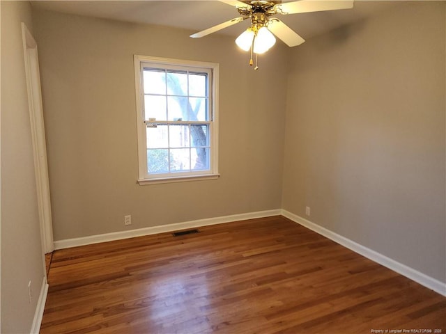 2814 Millbrook Rd, Fayetteville, NC 28303 - unfurnished room featuring dark wood-style floors, ceiling fan, visible vents, and baseboards