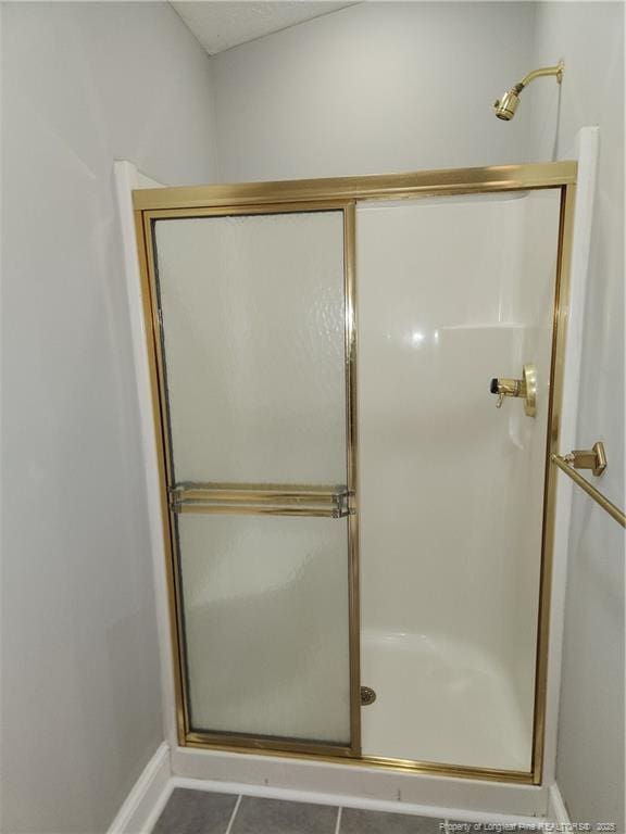 2814 Millbrook Rd, Fayetteville, NC 28303 - bathroom featuring tile patterned flooring, a shower stall, and baseboards