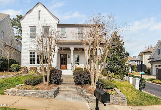 view of front of house with covered porch and brick siding