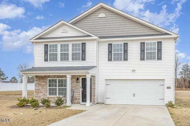 traditional-style home with a garage, stone siding, and concrete driveway