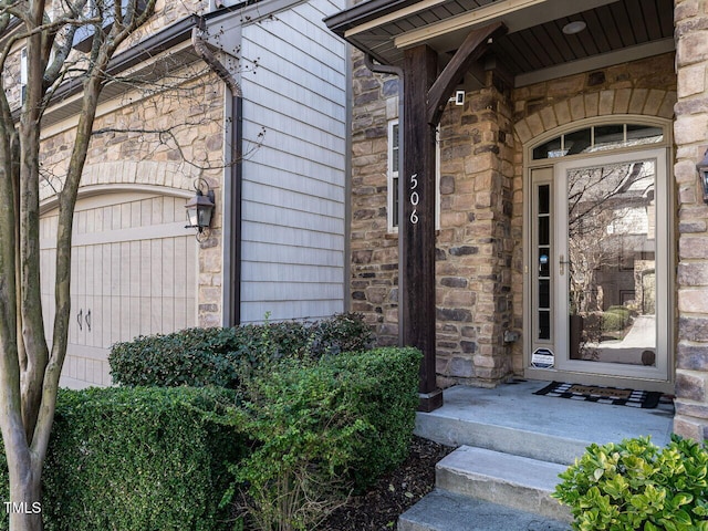 property entrance featuring stone siding