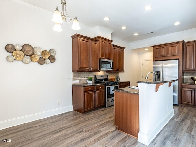 kitchen with stainless steel appliances, tasteful backsplash, and wood finished floors