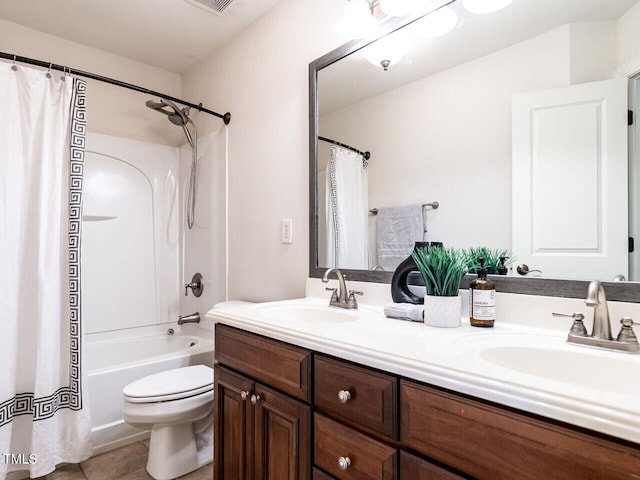 full bathroom with visible vents, double vanity, a sink, and toilet