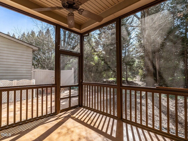 unfurnished sunroom with ceiling fan