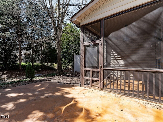 view of patio featuring a sunroom