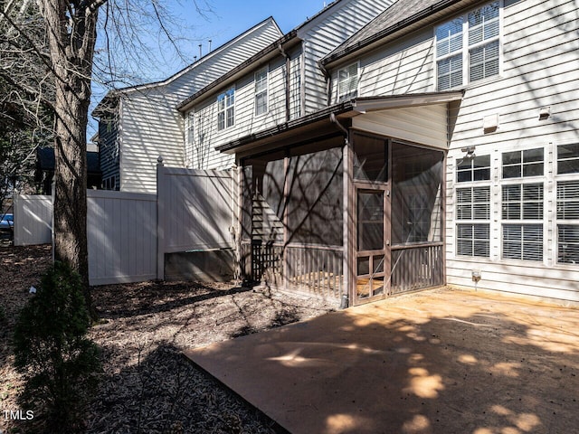 exterior space featuring a sunroom and fence