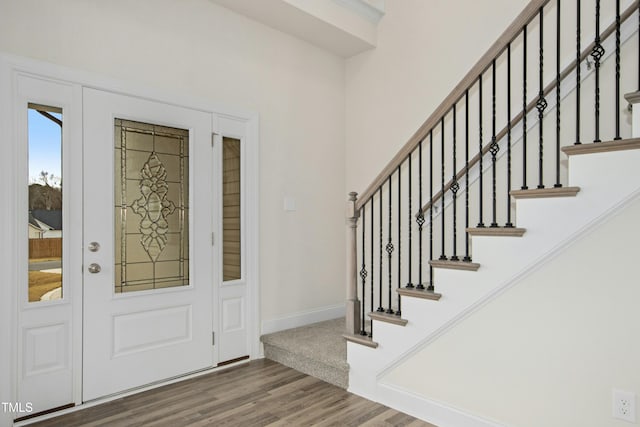 foyer featuring wood finished floors and baseboards