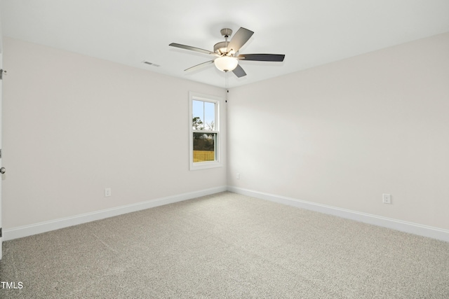 carpeted empty room with visible vents, a ceiling fan, and baseboards