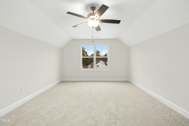 bonus room featuring vaulted ceiling, baseboards, a ceiling fan, and light colored carpet