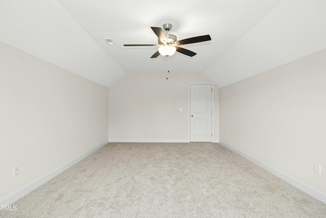 bonus room featuring lofted ceiling, baseboards, light carpet, and visible vents